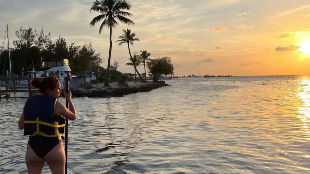 Woman paddling a paddle board along the Gulf Coast of the Florida Keys.